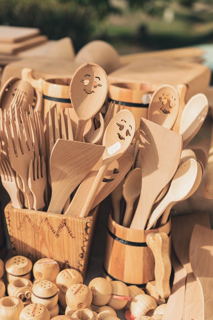 Charming collection of handmade wooden kitchen utensils with engraved designs, perfect for rustic decor.